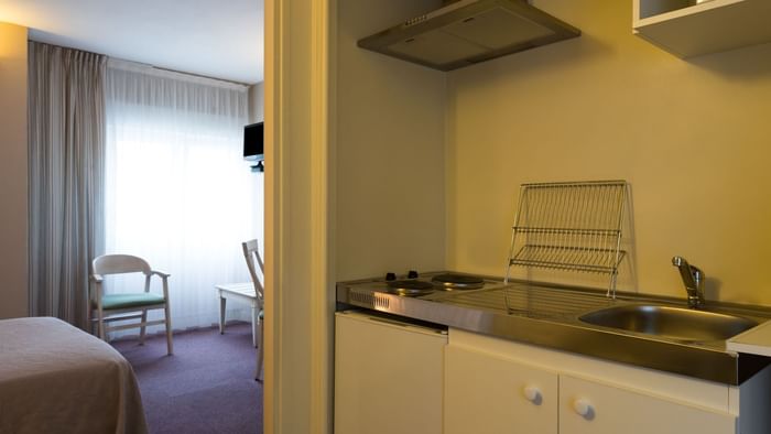 A kitchenette & Dining area in a hotel room at Hotel Cartier