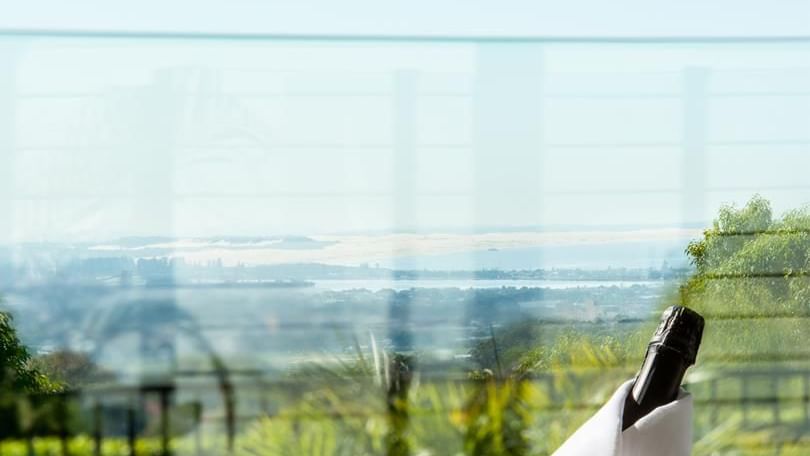 Champagne on ice and glasses served outdoors with a distant city view at Mercure Charlestown
