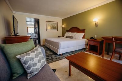 Couch and double bed in Junior Suite at Araiza Hotel Calafia