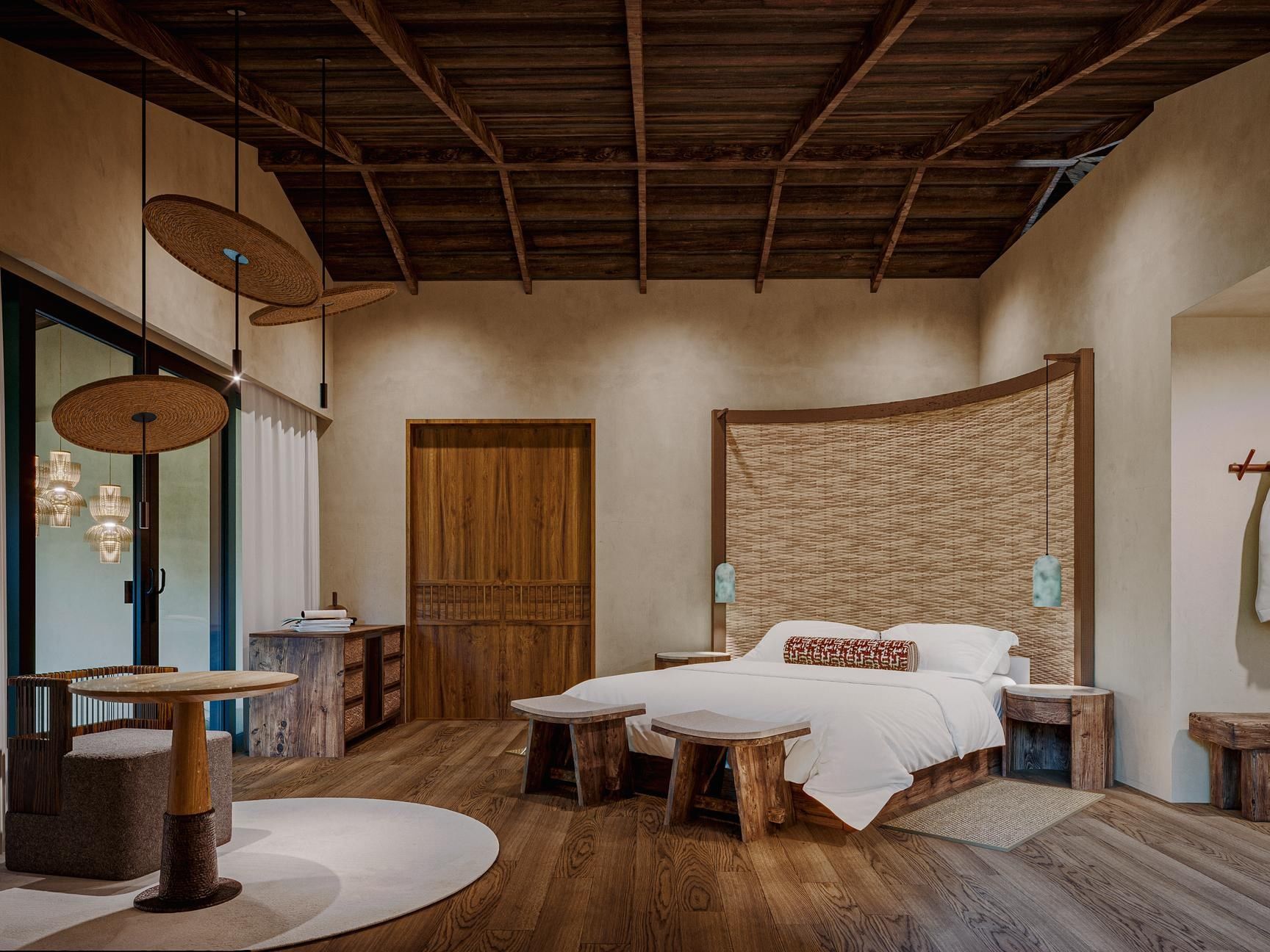 Bed with woven headboard & hanging lights over table in Deluxe River Bliss at Villa Lapas, Santa Lucia Jungle Hacienda