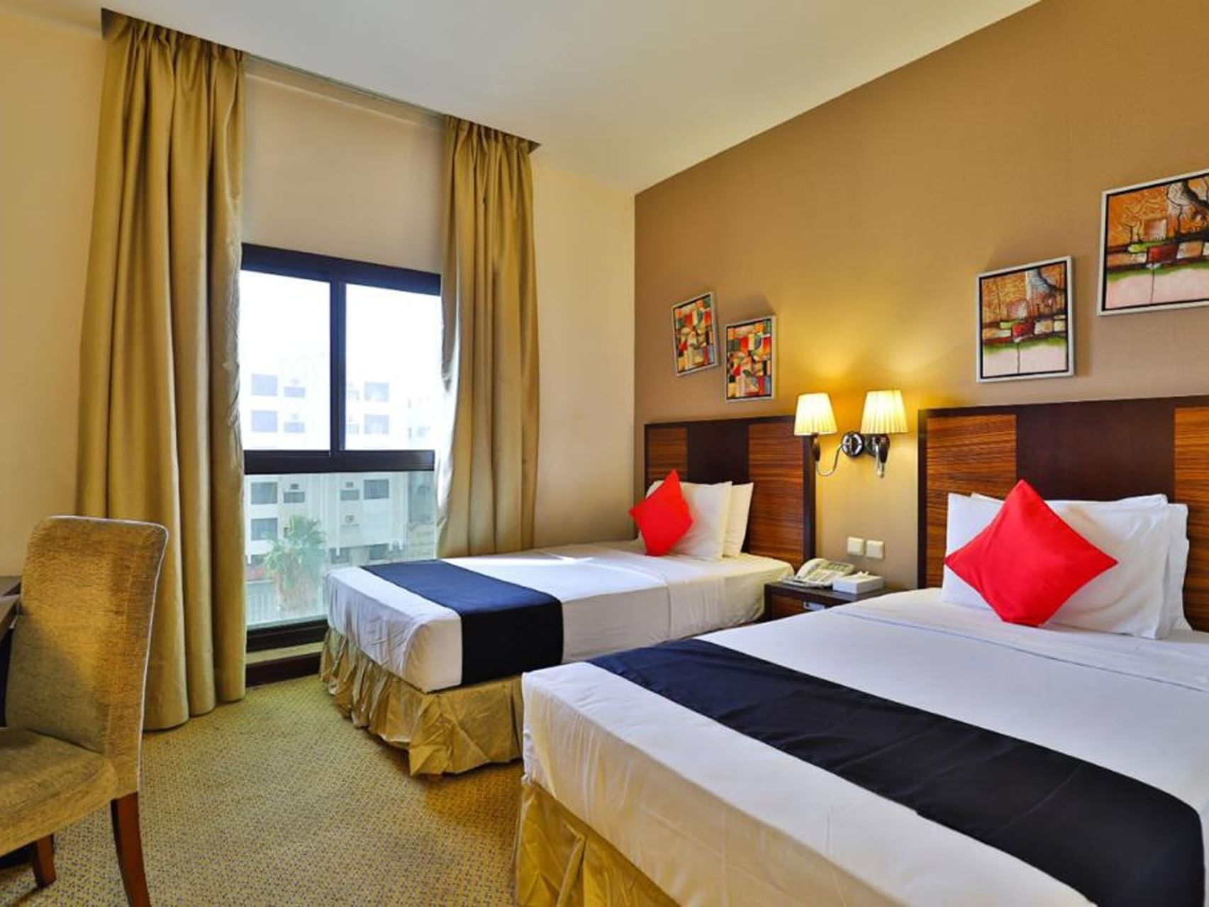 Standard room with twin beds and red pillow at Mena Hotel Taif
