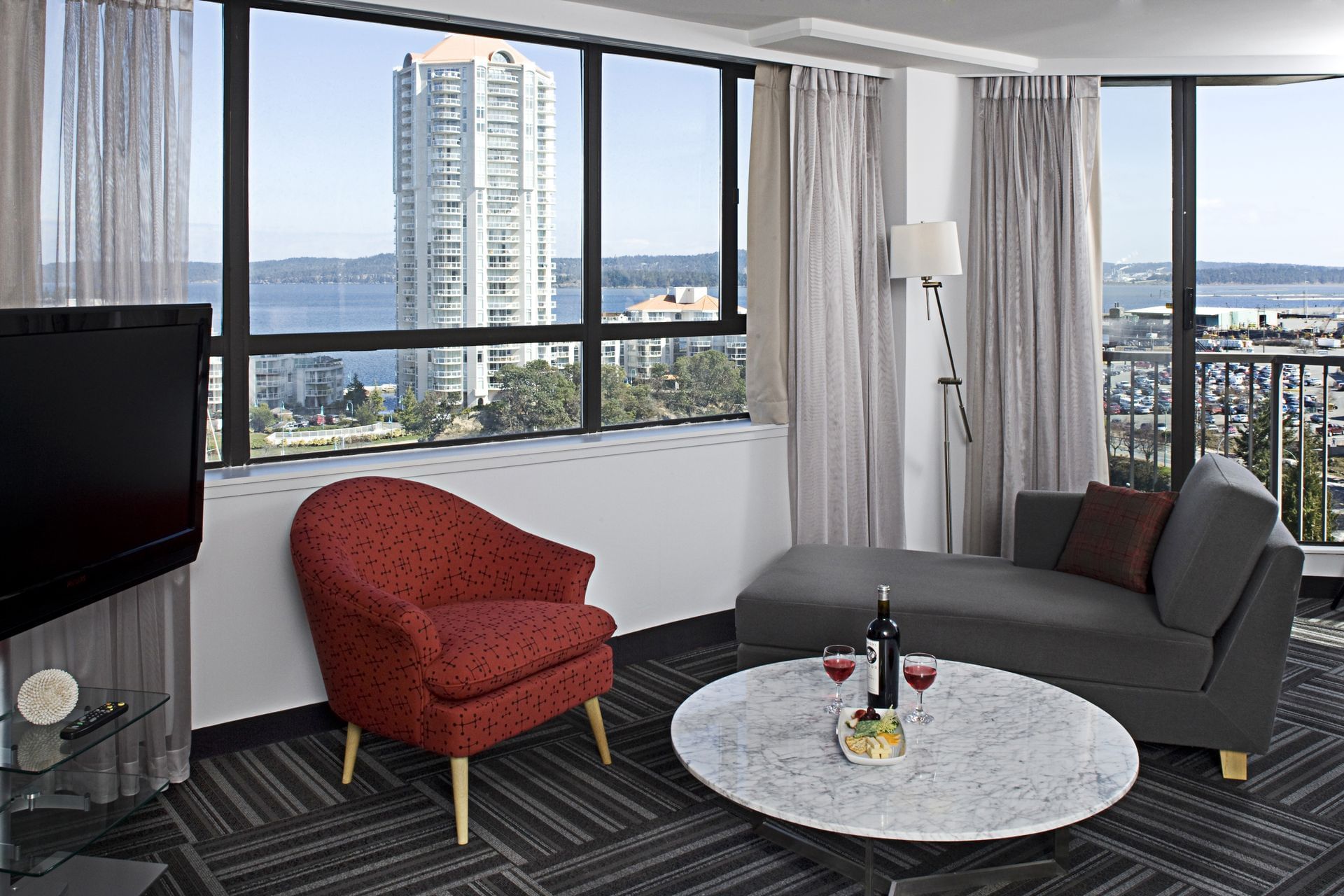 living room of hotel room overlooking city and ocean