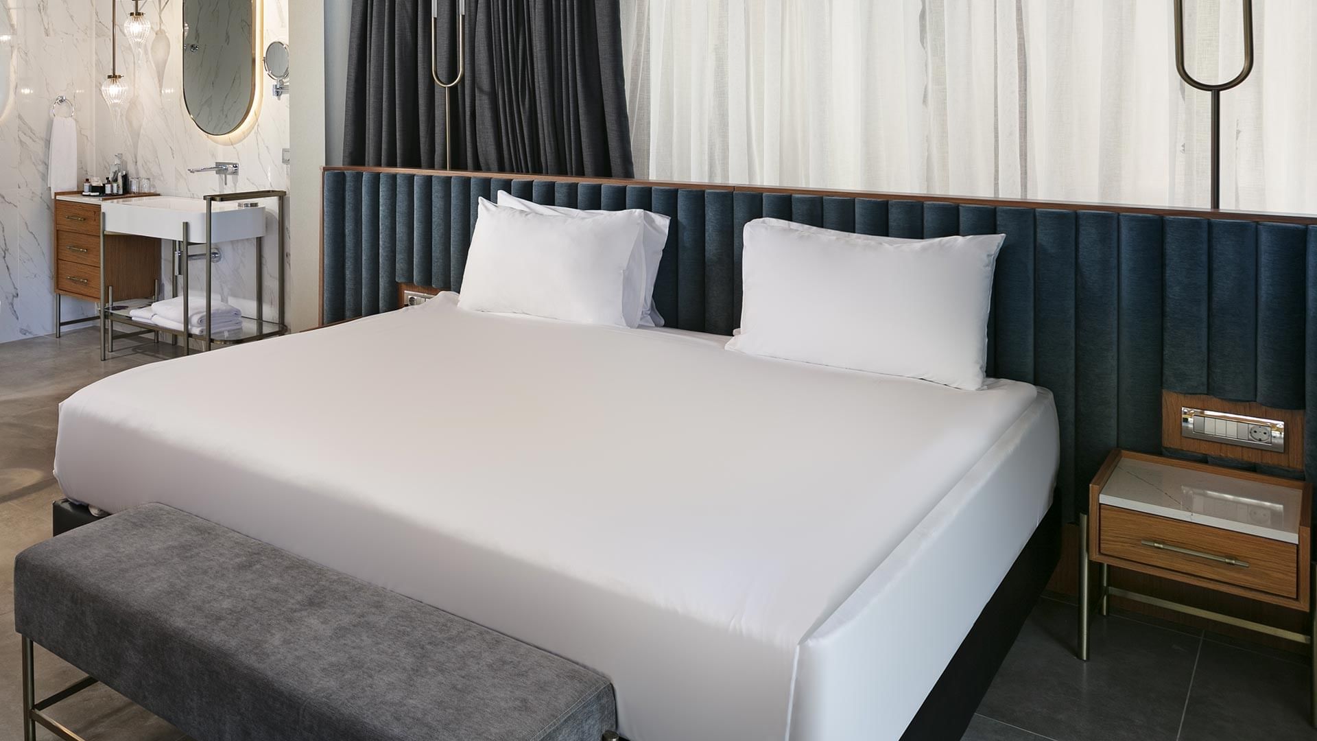 Comfy king-size bed with pillows in Bali House Garden at Titanic Deluxe Golf Belek