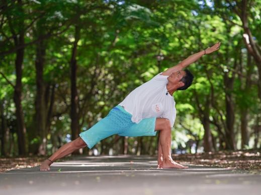 A man doing yoga poses outdoors at Chatrium Niseko japan
