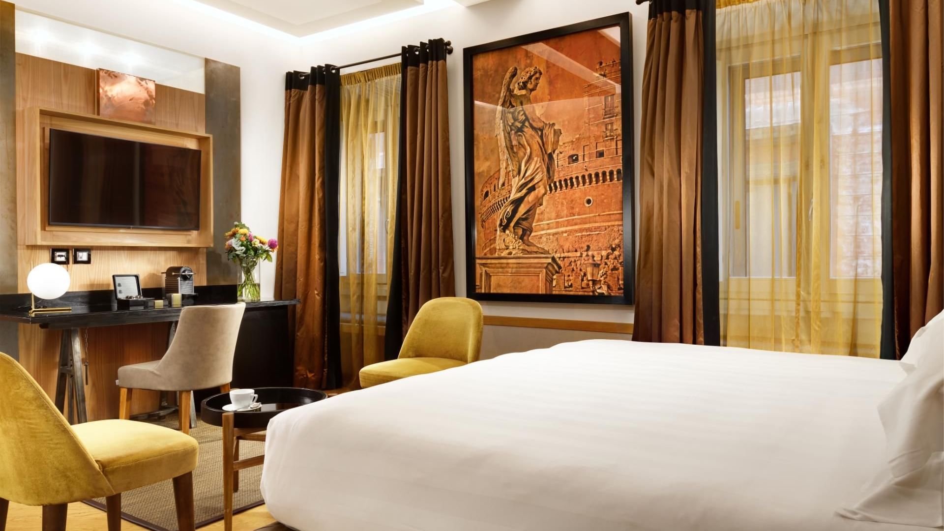 Work desk & TV facing king bed with city view in Deluxe Room at Babuino 181