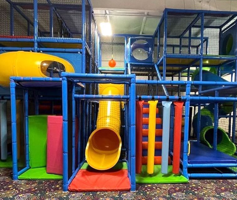 Multi-level indoor children\’s playground with blue metal structure in Bounce Town, near Avon Old Farms Hotel