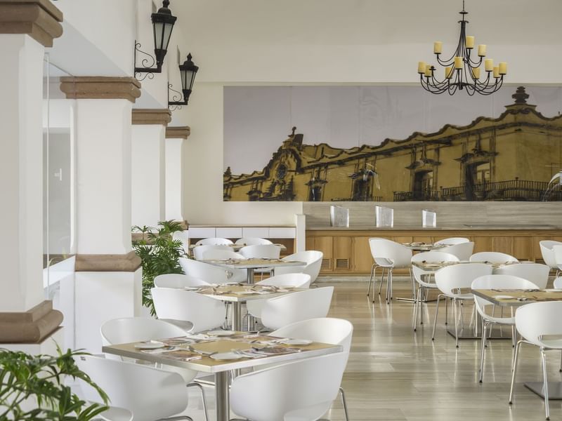 Restaurant with cutlery, chairs & tables at Fiesta Inn Hotels