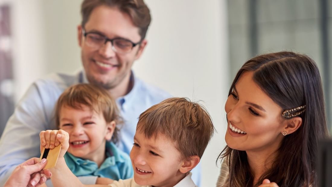 Family checking in by the front desk at Pullman Olympic Park