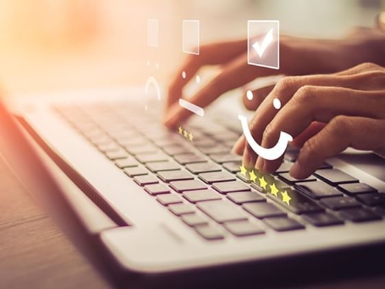 Close-up of a person typing on a laptop keyboard at Plaza Pelicanos Club Beach Resort