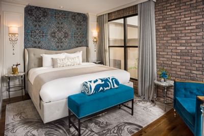 bed in cozy room with carpet and brick wall