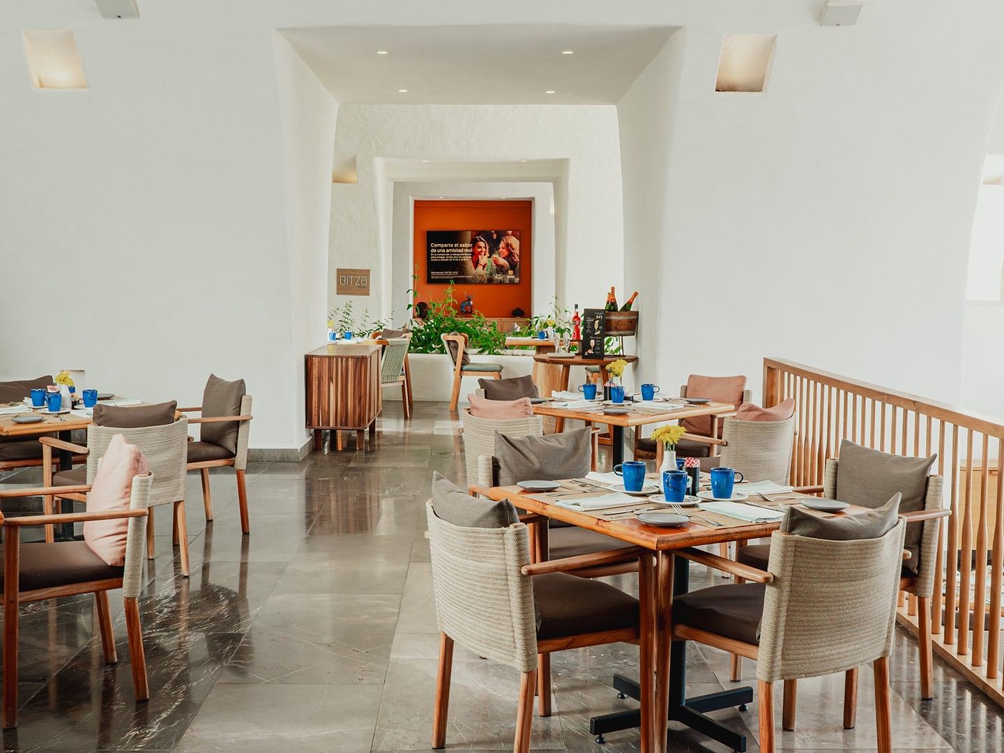 Dining area with cozy chairs and lush green plants in Chez Binni at Camino Real Zaashila Huatulco