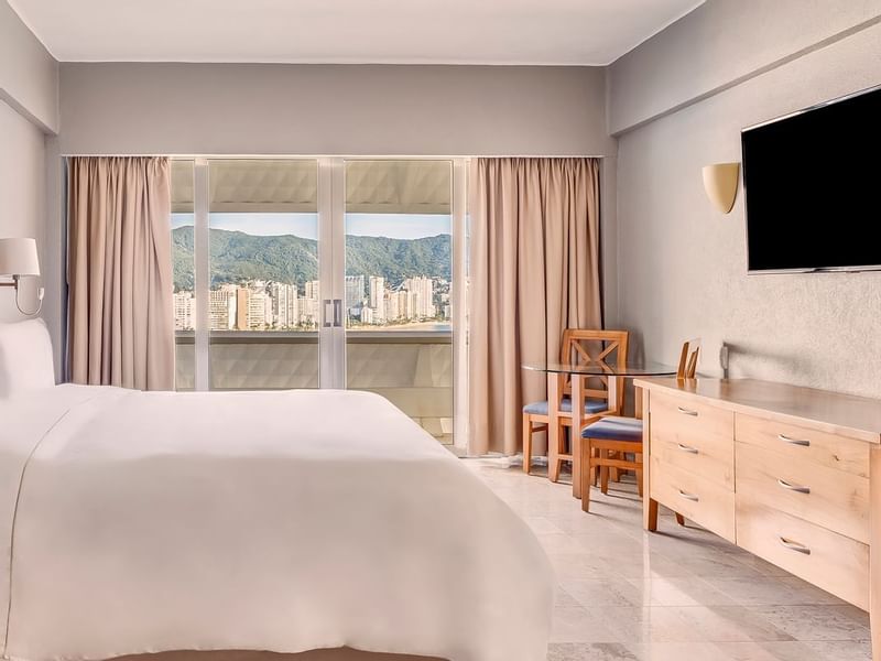 King bed with city view in Master Suite at Fiesta Americana