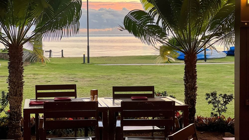 Tables and chairs with ocean view at The Naviti Resort in Korolevu.