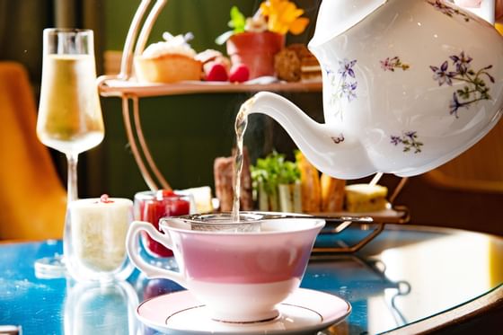 Closeup of a kettle pouring tea into a cup at Richmond Hill