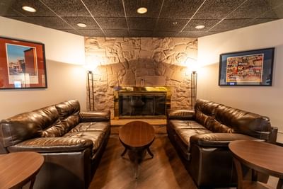 Comfy lounge area by a fireplace in Twigs Bar & Lounge at M Hotel Buffalo