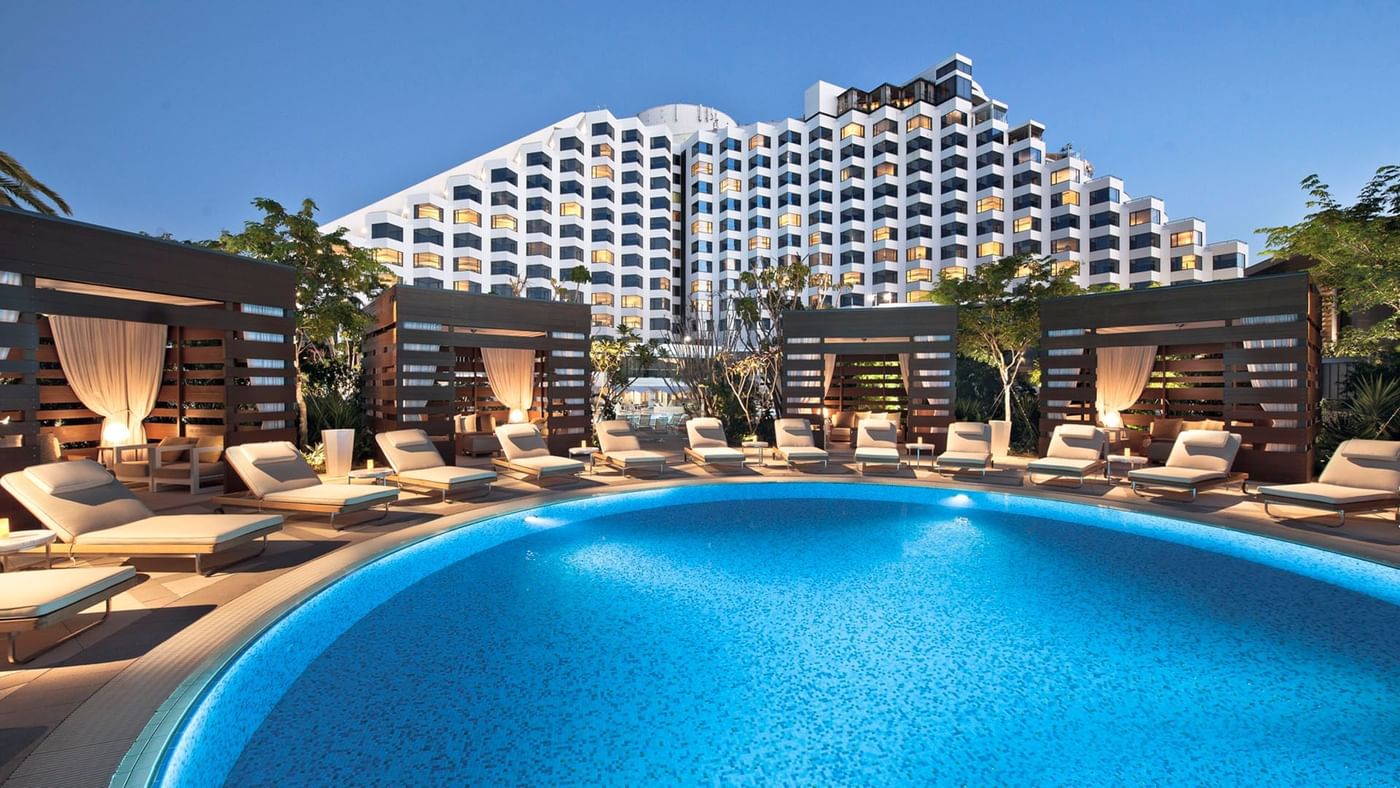 Exterior view of Crown Metropol Perth with pool beds and cabanas