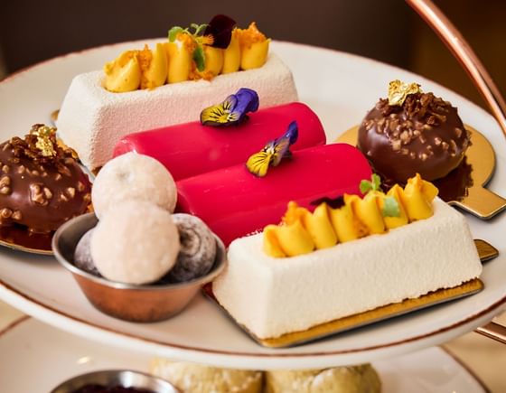 Hand-crafted patisserie at May Fair Kitchen Afternoon Tea — hazelnut mousse and Charbonnel et Walker truffles