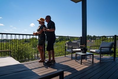 Couple enjoying champagne on the Earl suite balcony