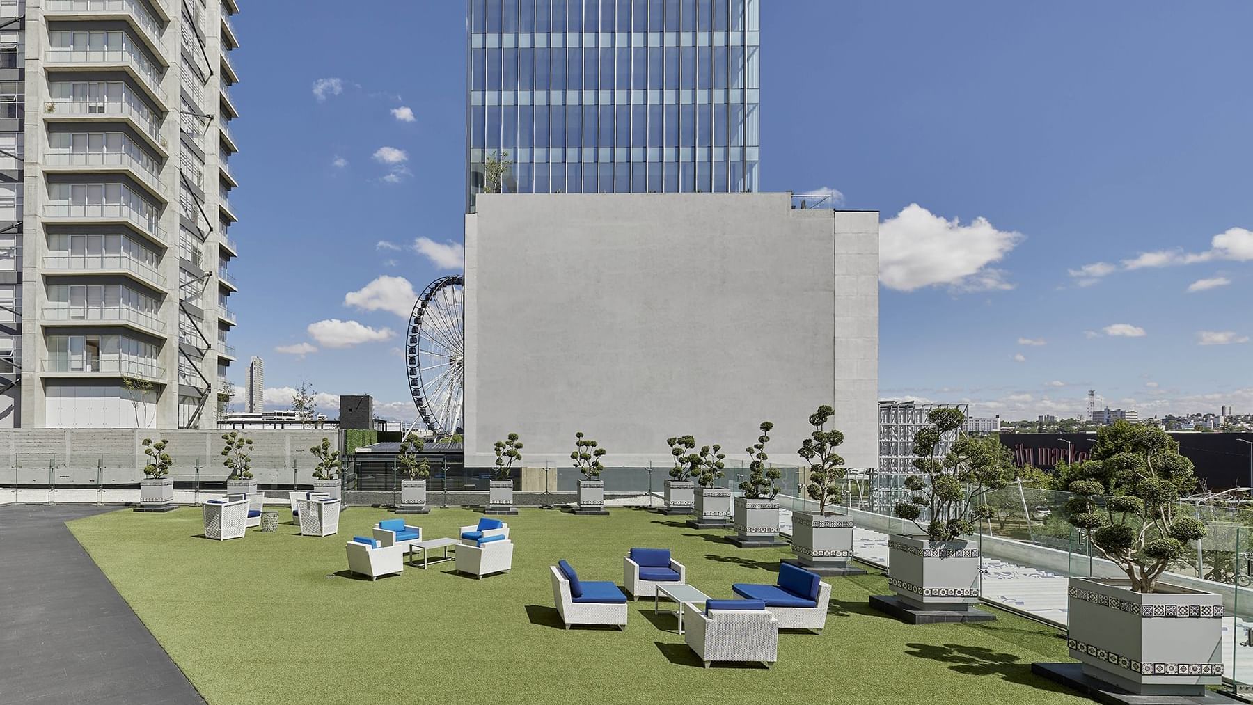 Rooftop lounge area with city view at Grand Fiesta Americana