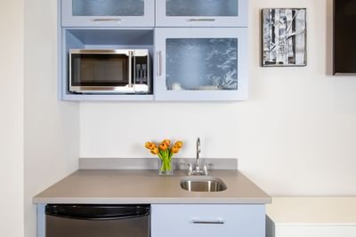 Kitchenette with fresh flowers & appliances in King Premiere Studio at Retro Suites Hotel