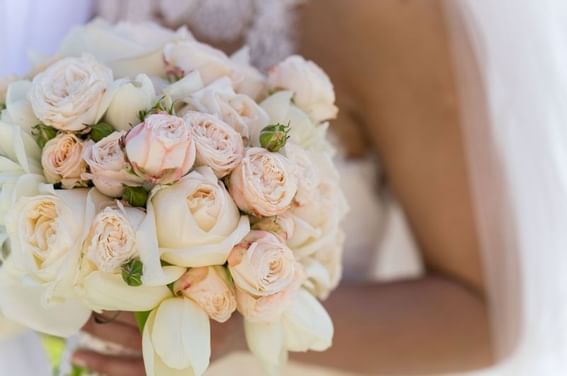 Close-up of a bride posing with her bouquet at The Abidah Hotel