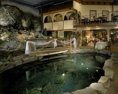 Koi pond with realistic rock outcroppings in courtyard