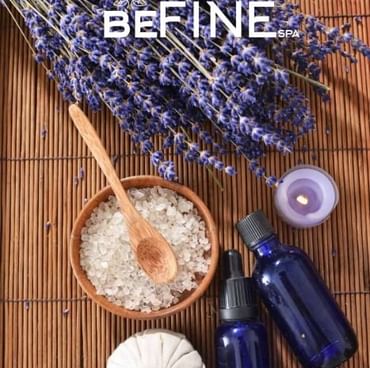 A spa setting with lavender, sea salt with a spoon, and a candle at Titanic Deluxe Golf Belek