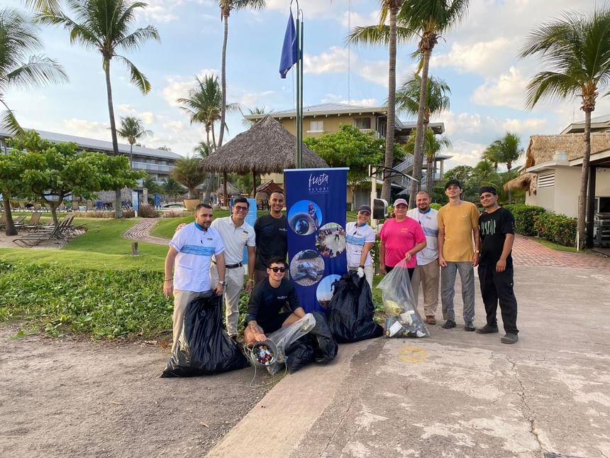 Volunteers smilingly posing for a photo near Fiesta Resort