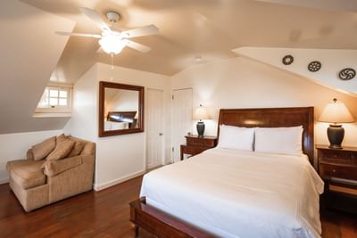 Comfy bed, side tables, and interior of Crow's Nest at Banning House Lodge
