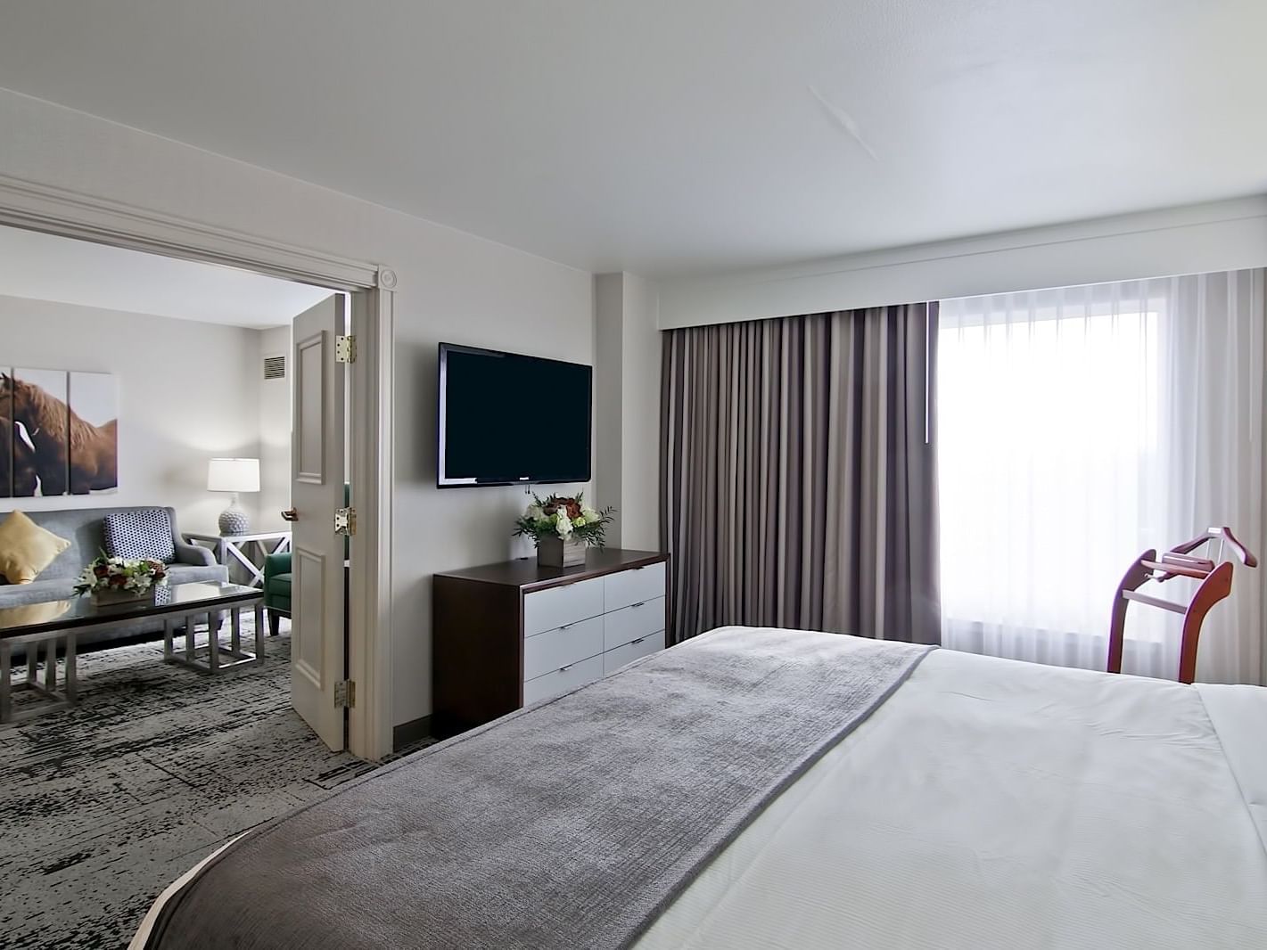 Bedroom and living area in King Grand Suite at Grove Hotel