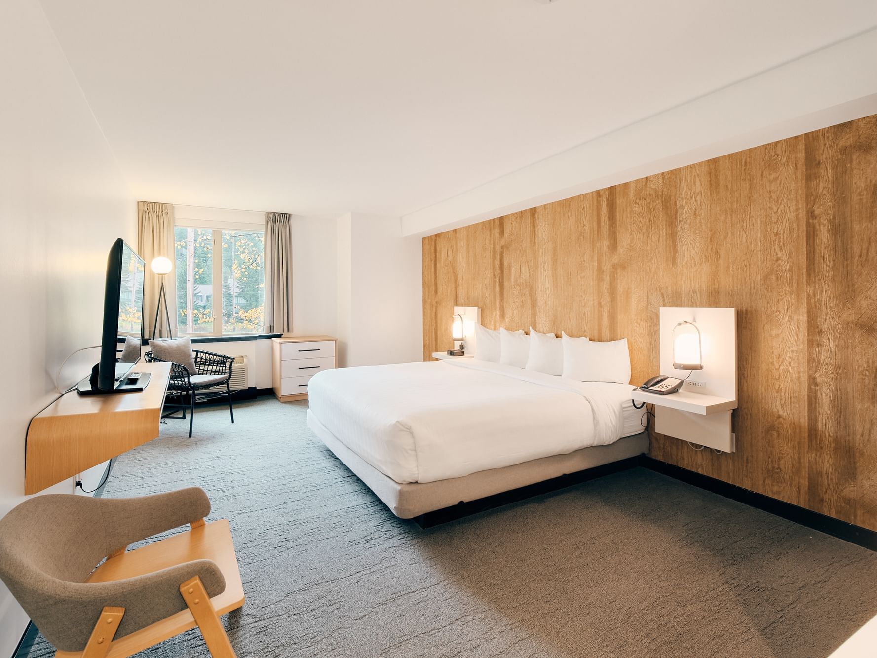 Bed in hotel room with wooden walls