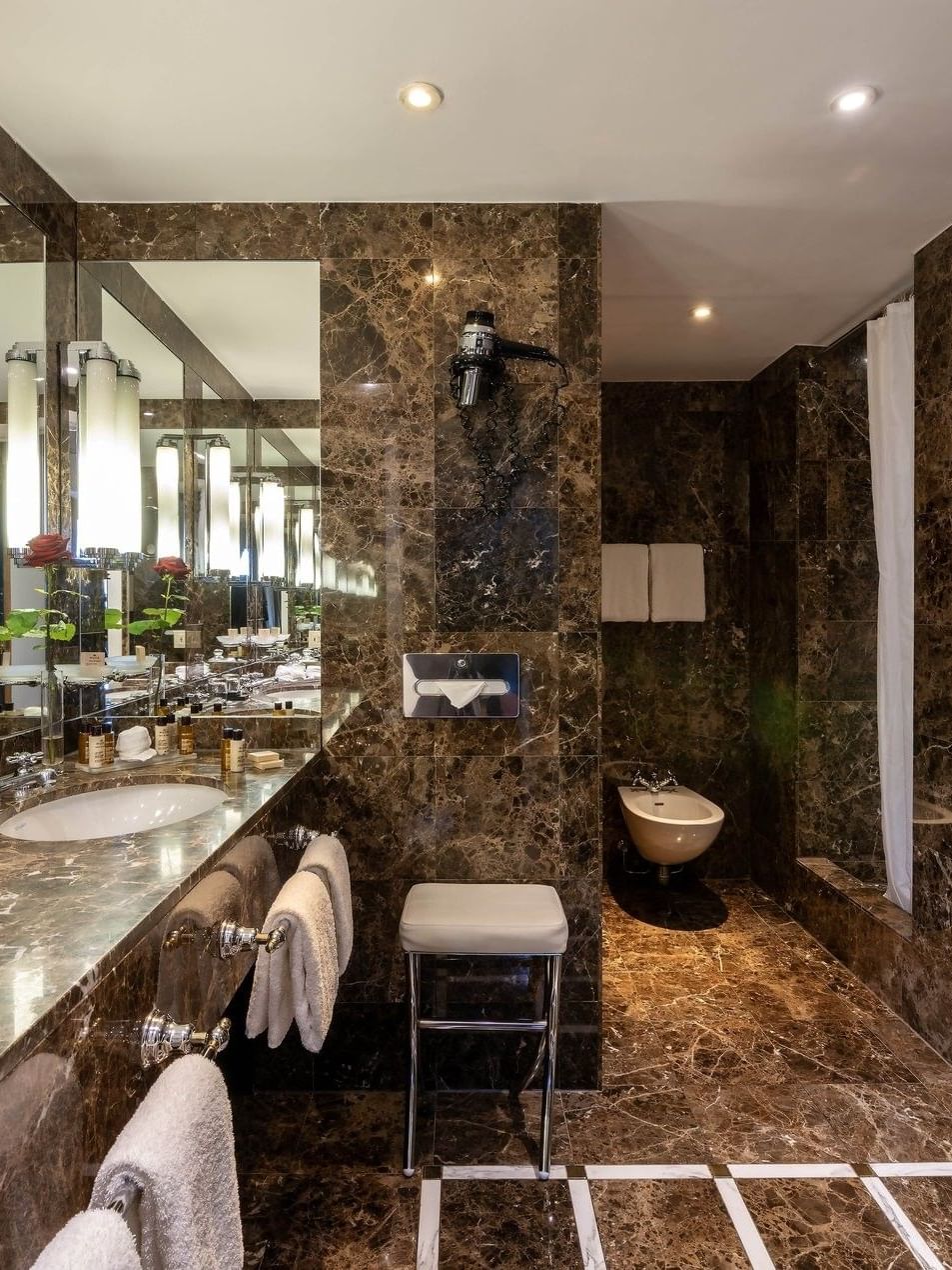 Royal Suite bathroom featuring a marble vanity with a mirror near the bathtub at Warwick Grand Place Brussels