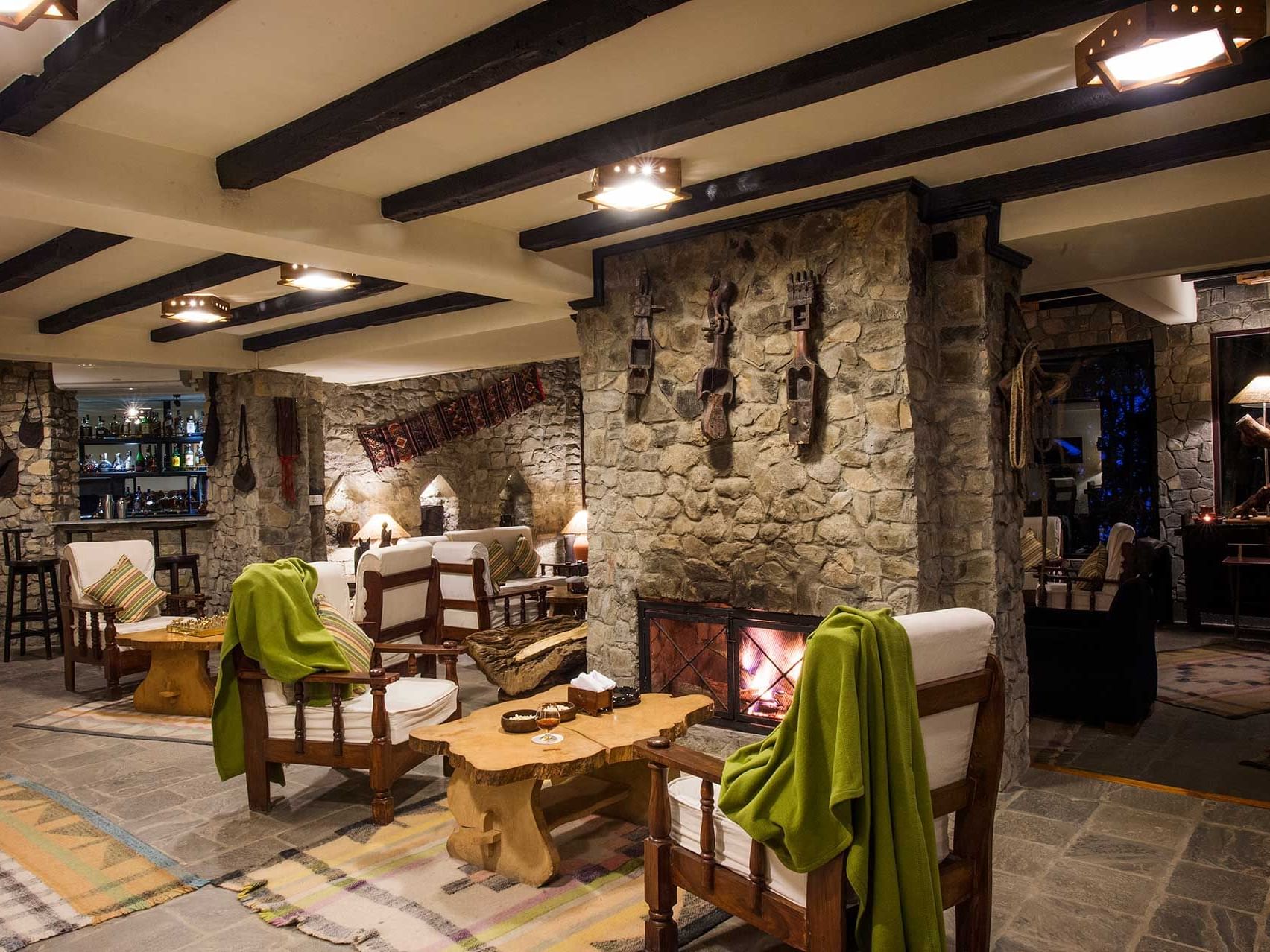 Lounge area with a bricked wall and fireplace at The Dwarika’s Hotels and Resorts