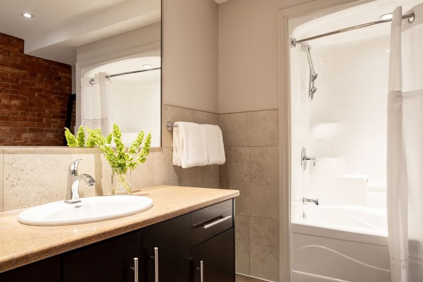 Bathroom vanity & shower in Apartment 201 at Retro Suites Hotel