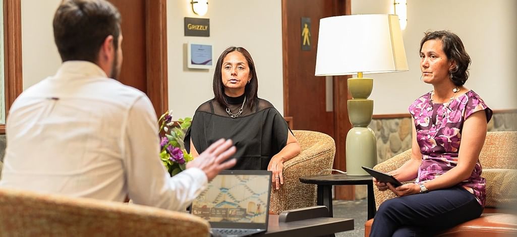 A small team uses a hotel lobby for a break-out meeting during a corporate retreat in Canmore.