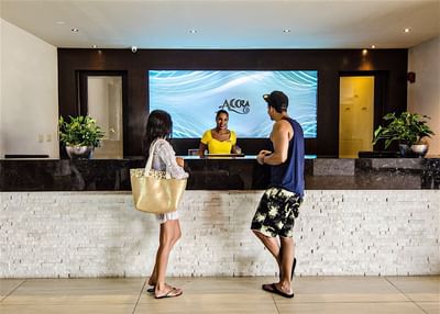 Couple talking to a receptionist by the front desk at Accra Hotels & Resorts