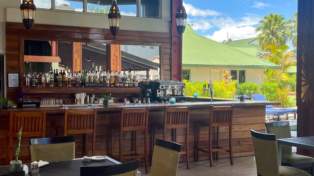 Bar with many liquor bottles and seating at Tokatoka Resort in Nadi.