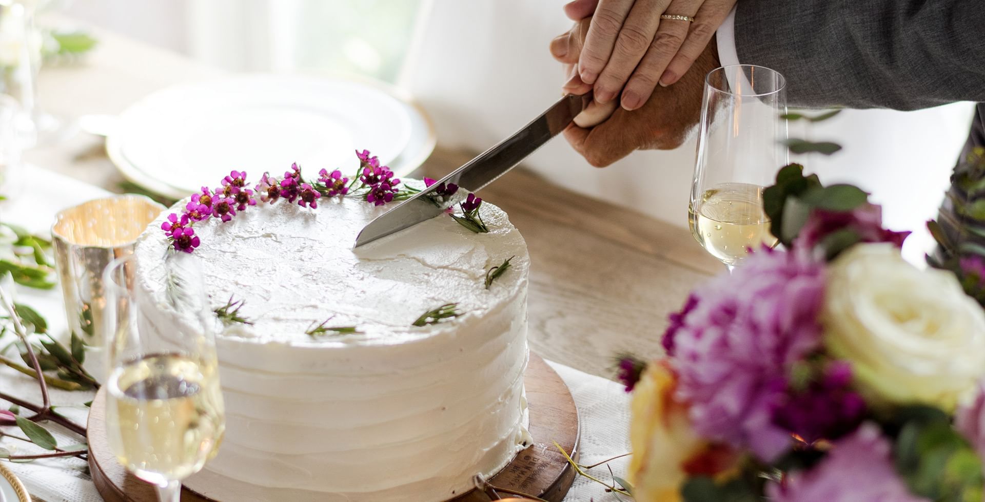 Knife cutting into a wedding cake