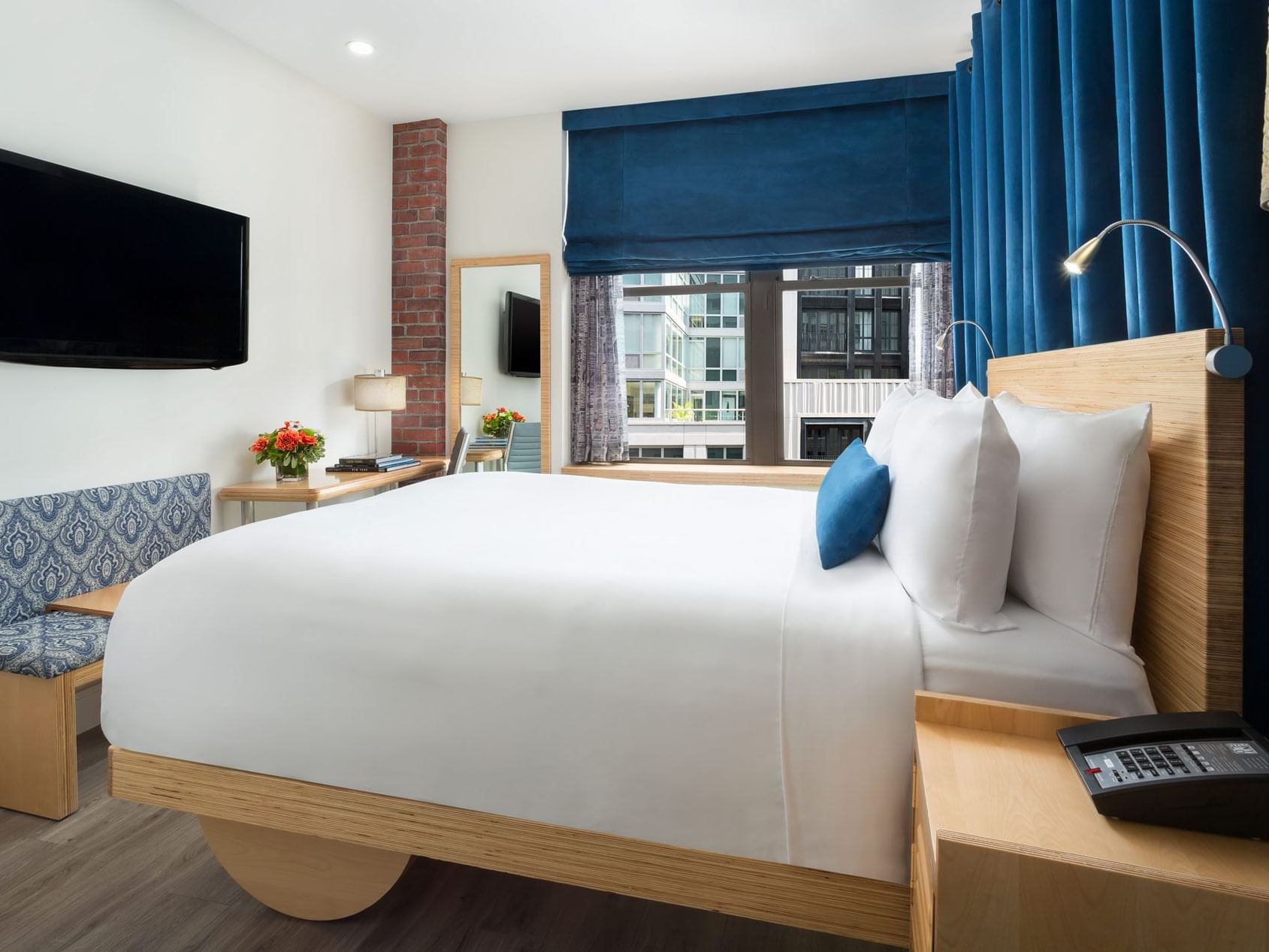 a bed facing a wall-mounted tv