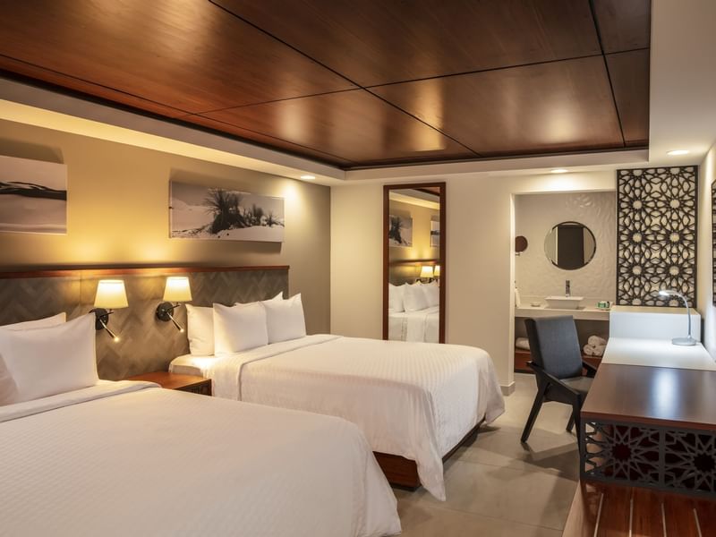 Beds, desk & vanity in Deluxe Double Room at Gamma Hotels