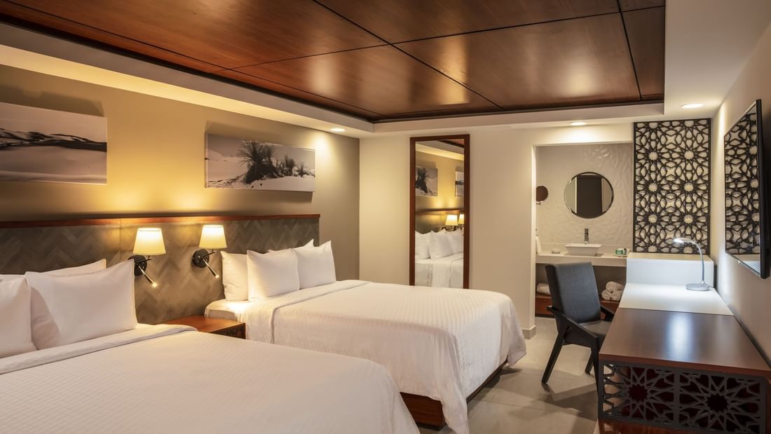 Beds, desk & vanity in Deluxe Double Room at Gamma Hotels