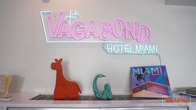 a neon sign of the vagabond hotel miami in the meeting room