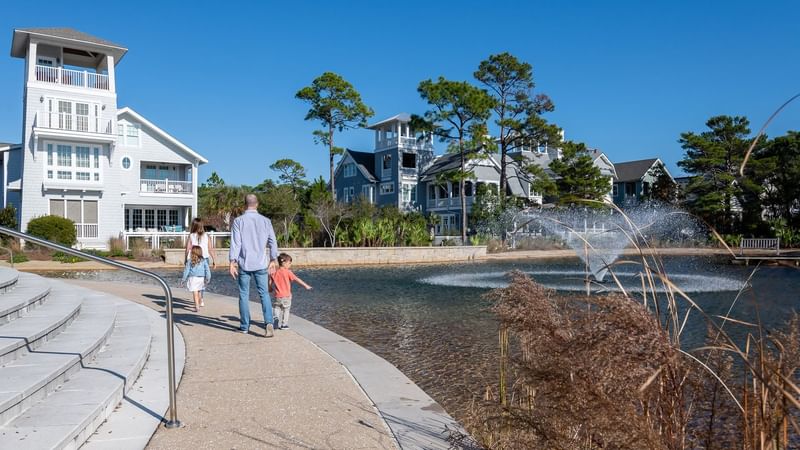 Family taking a walk by the lake at Watersound Inn