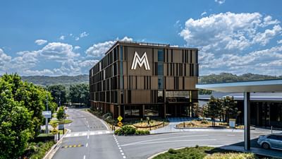 Encore By Mingara with a prominent M logo, surrounded by greenery and blue skies