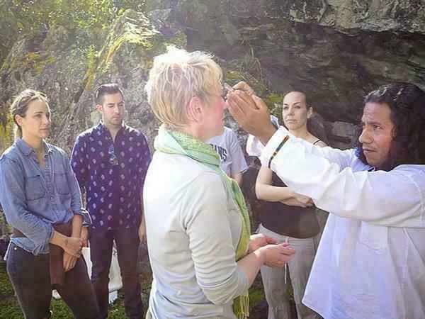 A group of tourists with a priest in the woods near Hotel Sumaq