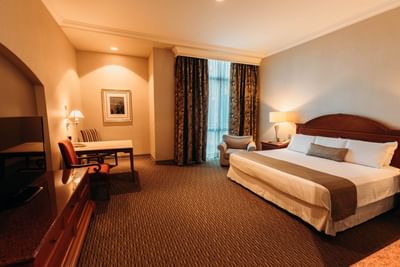 Large bed & desk in Executive Room at Araiza Mexicali