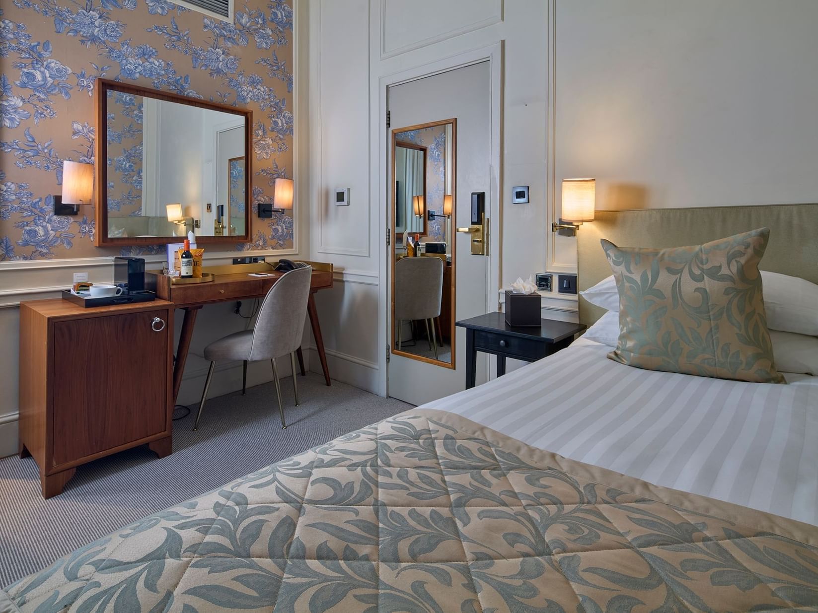 Single room In Sloane Square Hotel featuring a bed, with warm lighting