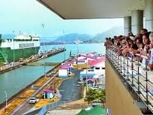 people looking over panama canal