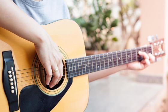 Close-up picture of a person playing the guitar