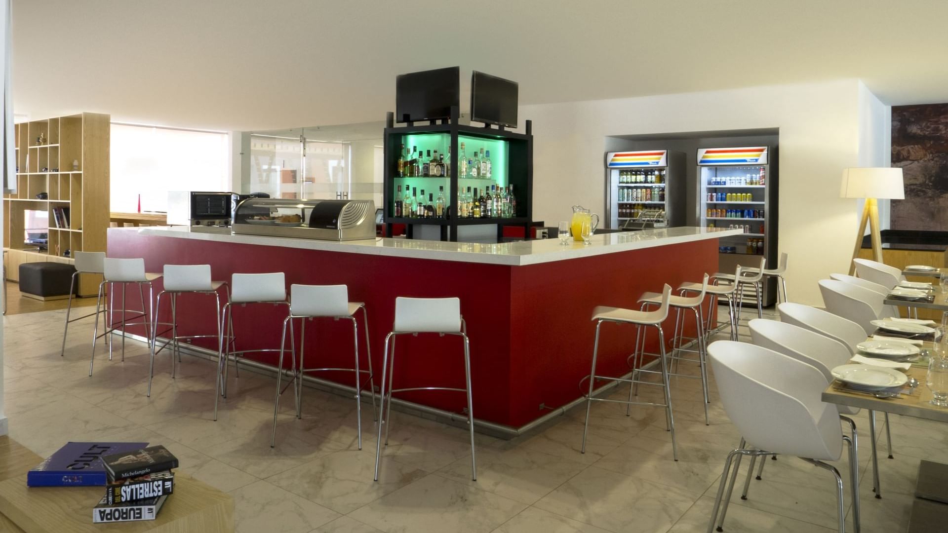 Bar counter with stools in a restaurant at Fiesta Inn León